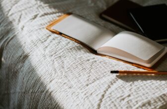 A serene workspace with an open journal, a pen, and calming elements like candles and plants, evoking a sense of self-discovery and reflection.