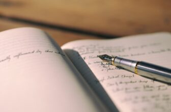 A serene workspace with an open journal, a pen, and calming elements like candles and plants, symbolizing reflection and spirituality.